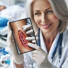 A woman holding an image of the back of her mouth.